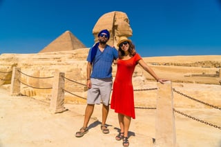 A Tourist Couple At The Great Sphinx Of Giza And In The Background The Pyramids Of Giza The Oldest