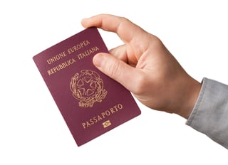 Hand Hold An Italian Passport On White Background