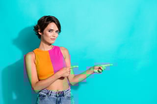 Photo Of Cute Sweet Woman Wear Pink Orange Top Showing Two Fingers Empty Space Isolated Teal Color