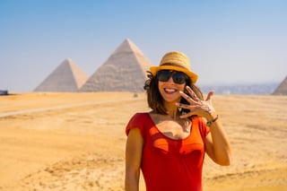 Portrait Of A Young Tourist In Red Dress Enjoying The Pyramids Of Giza The Oldest Funerary Monument