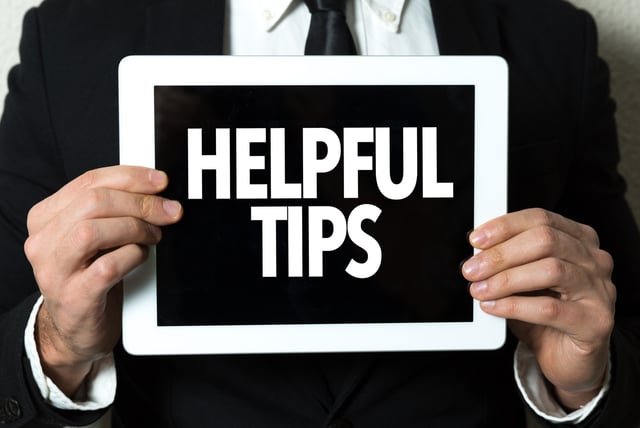 Person Holding Tablet With Helpful Tips