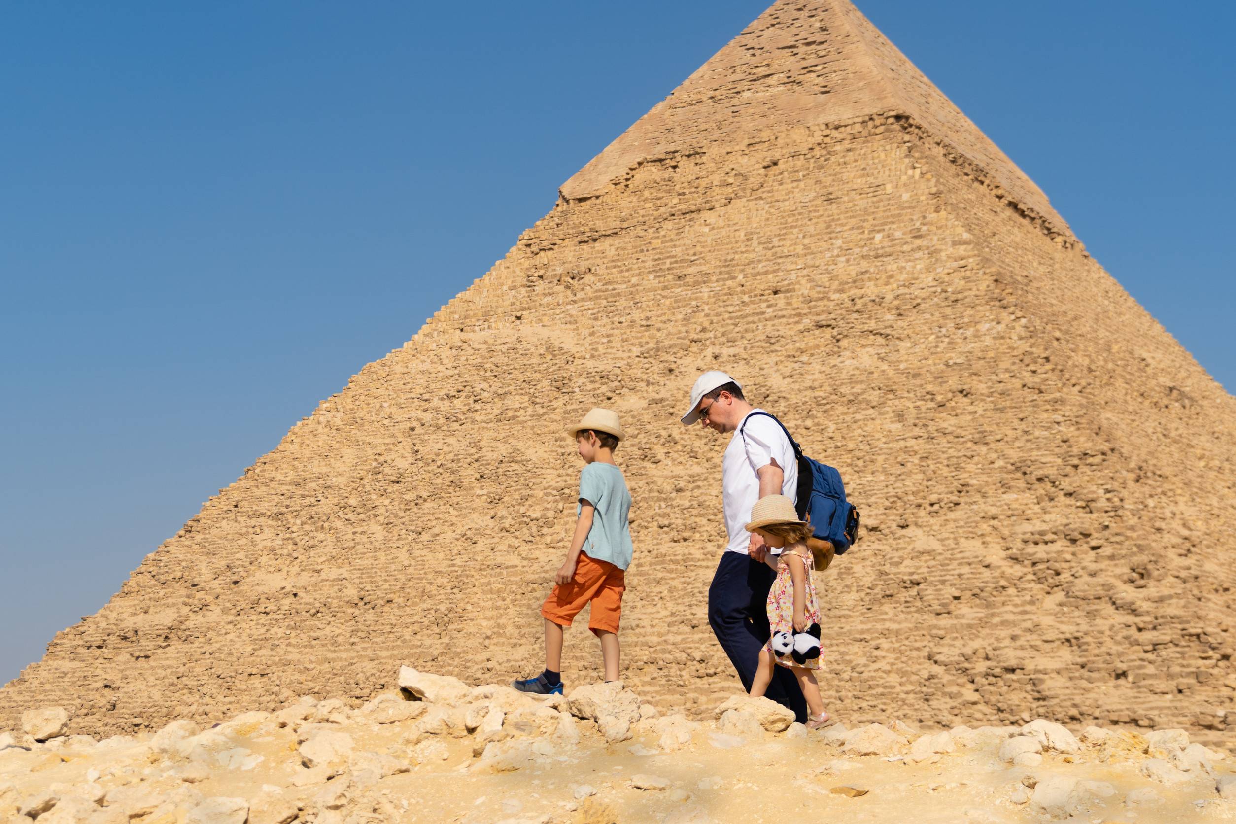 Travellers walk in front of the Chephren pyramid on the Giza plateau